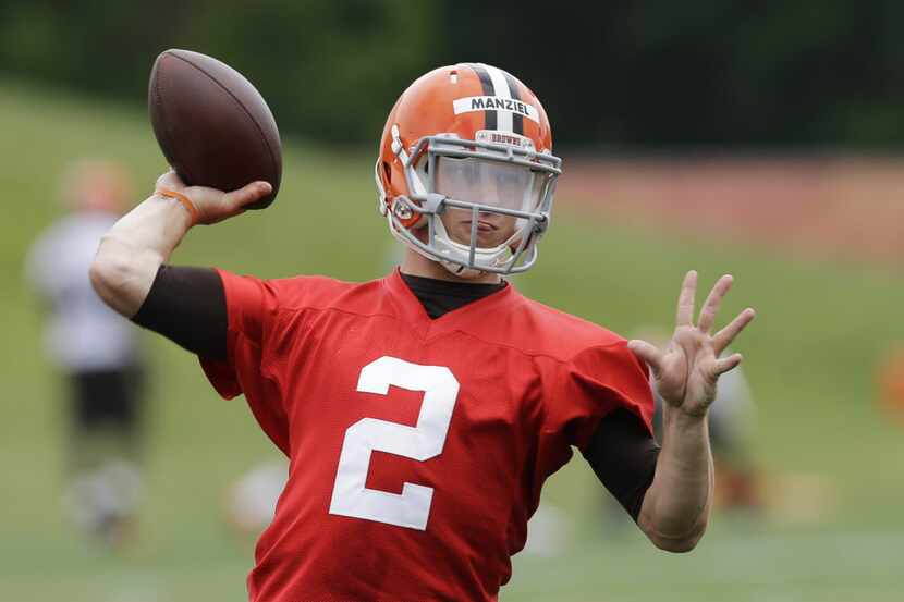 Cleveland Browns quarterback Johnny Manziel passes during a mandatory minicamp practice at...