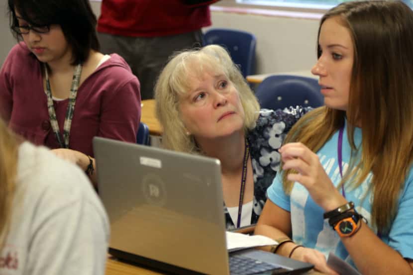 Richardson High School teacher Patricia Hofeditz spends some one-on-one time with senior...