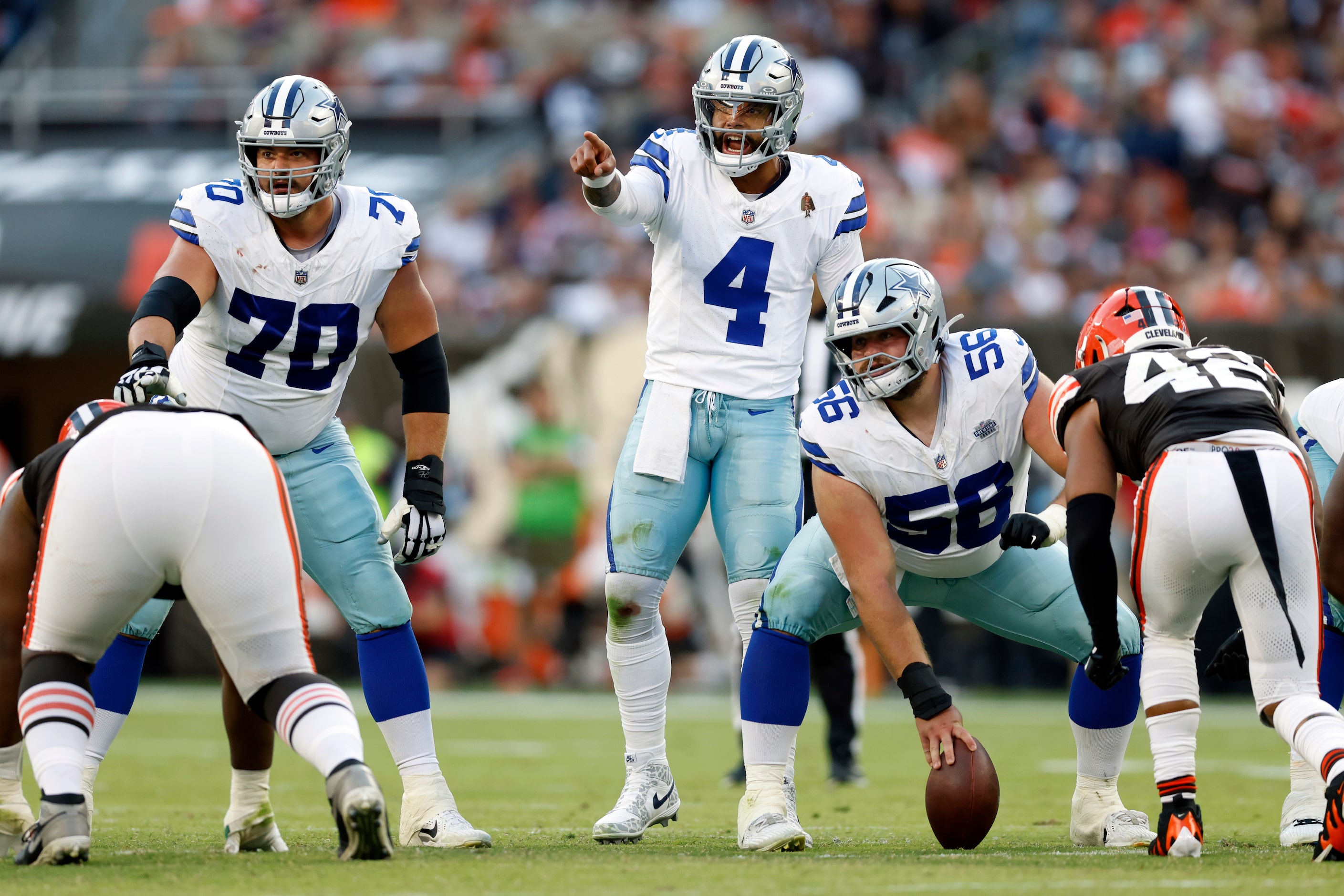 Dallas Cowboys quarterback Dak Prescott (4) calls out a Cleveland Browns defender alongside...