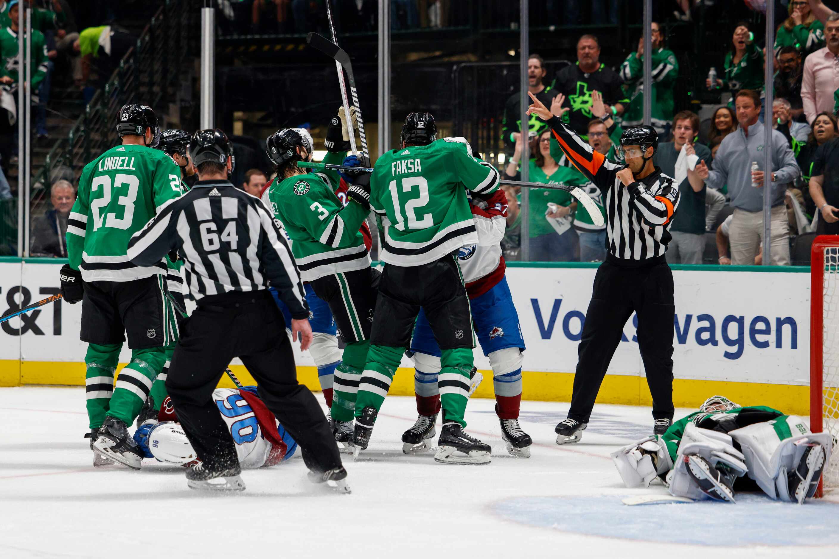 Dallas Stars and Colorado Avalanche players come together after a stoppage in play during...