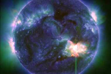 This image provided by NASA shows a solar flare -- the bright flash in the lower right --...