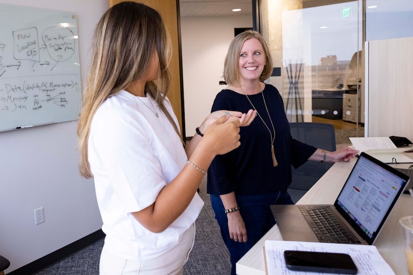 Camelot account management’s Aubri Elliott (left) and Erika Newsom chat before a client...