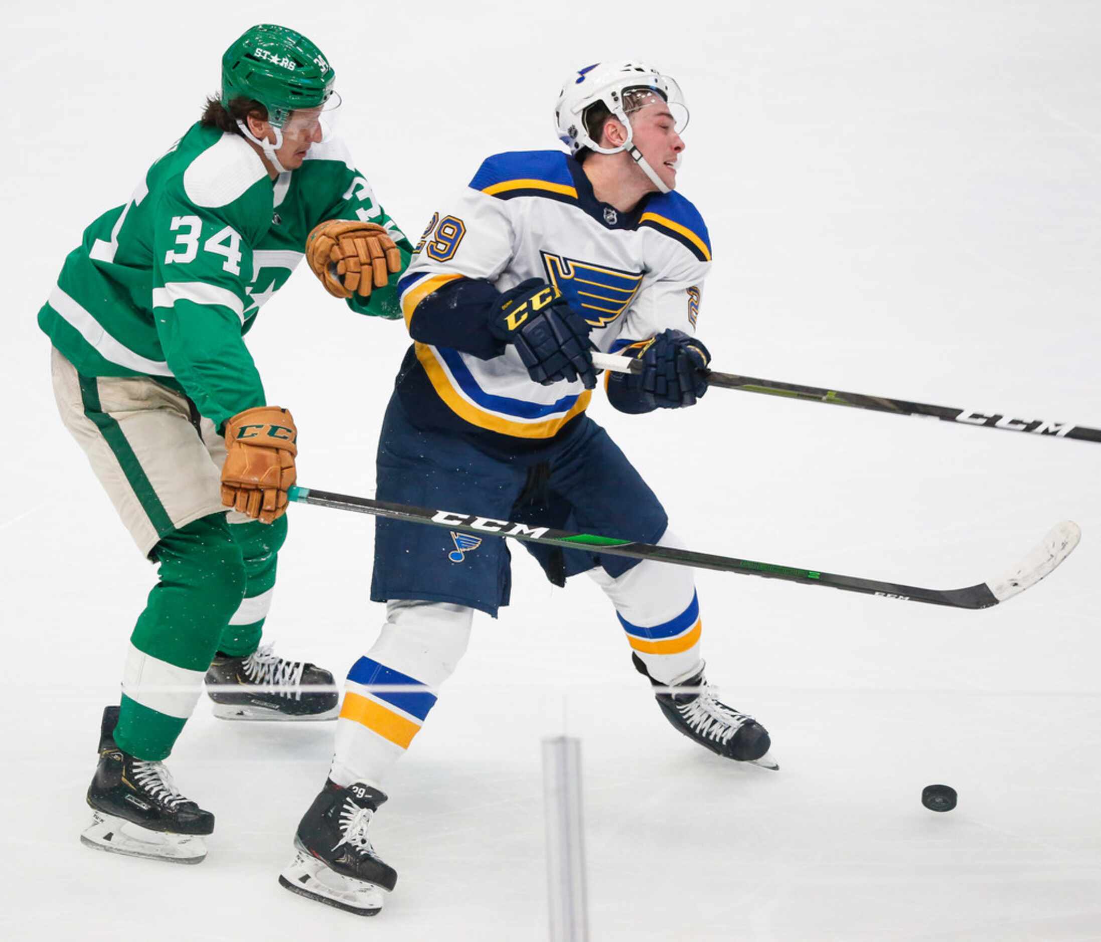 Dallas Stars right wing Denis Gurianov (34) and St. Louis Blues defenseman Vince Dunn (29)...
