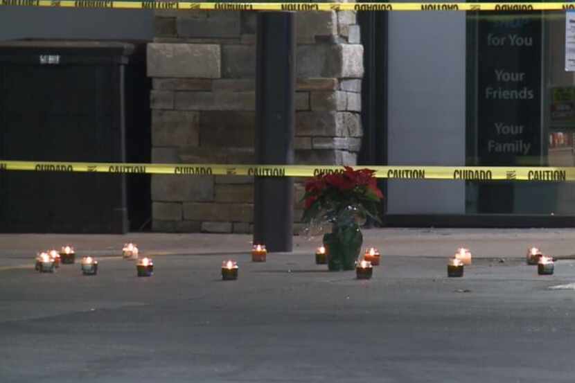 A memorial with candles was set up shortly after a man died in a shooting at a convenience...