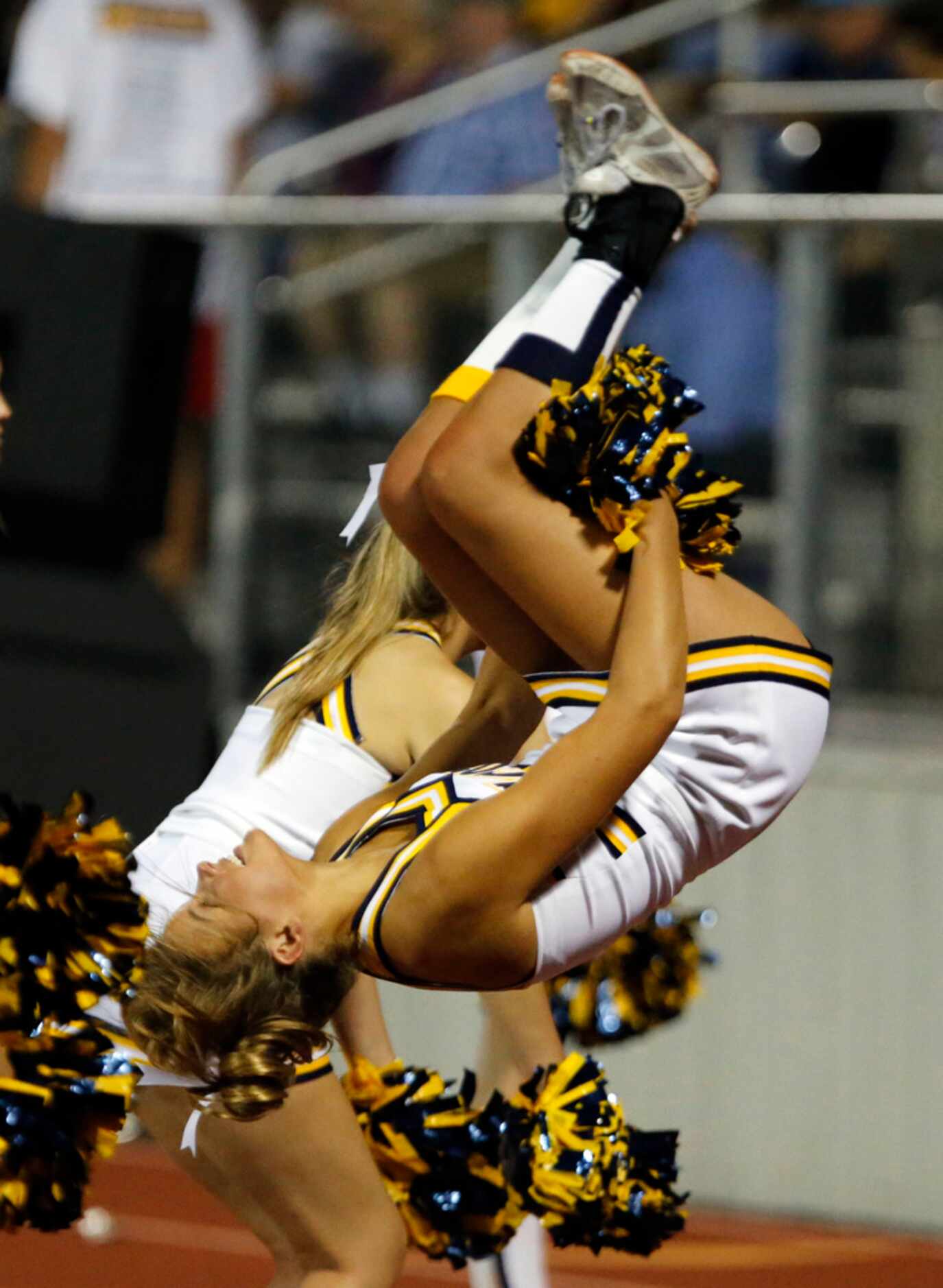 A Highland Park cheerleader flips after another Scot's touchdown during the first half of...
