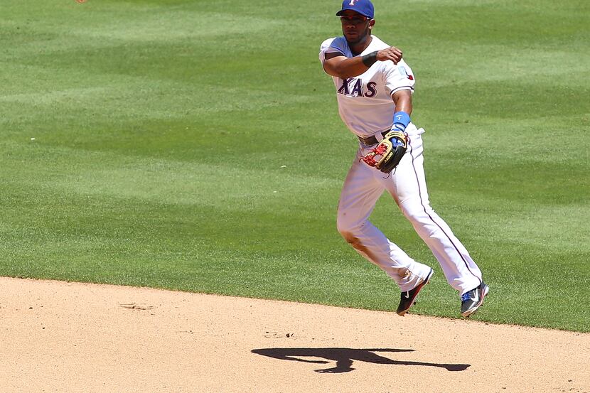 Elvis Andrus of the Texas Rangers throws to first base for the out against the Oakland...