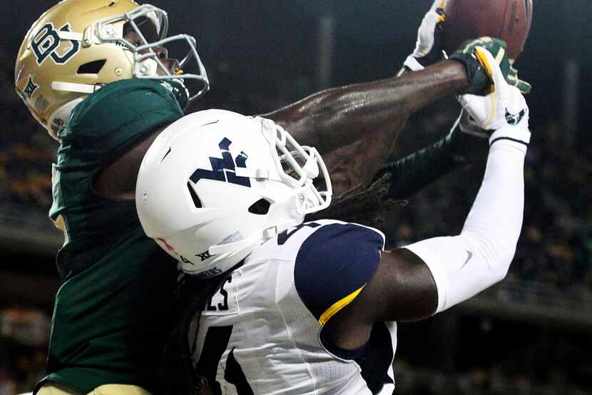 West Virginia cornerback Mike Daniels Jr. (4) breaks up a pass intended for Baylor wide...