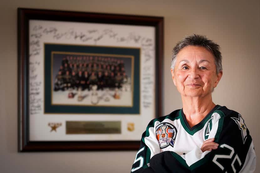 Donna Hanna photographed with her autographed photo of 1999 Stars Stanley Cup-winning team...
