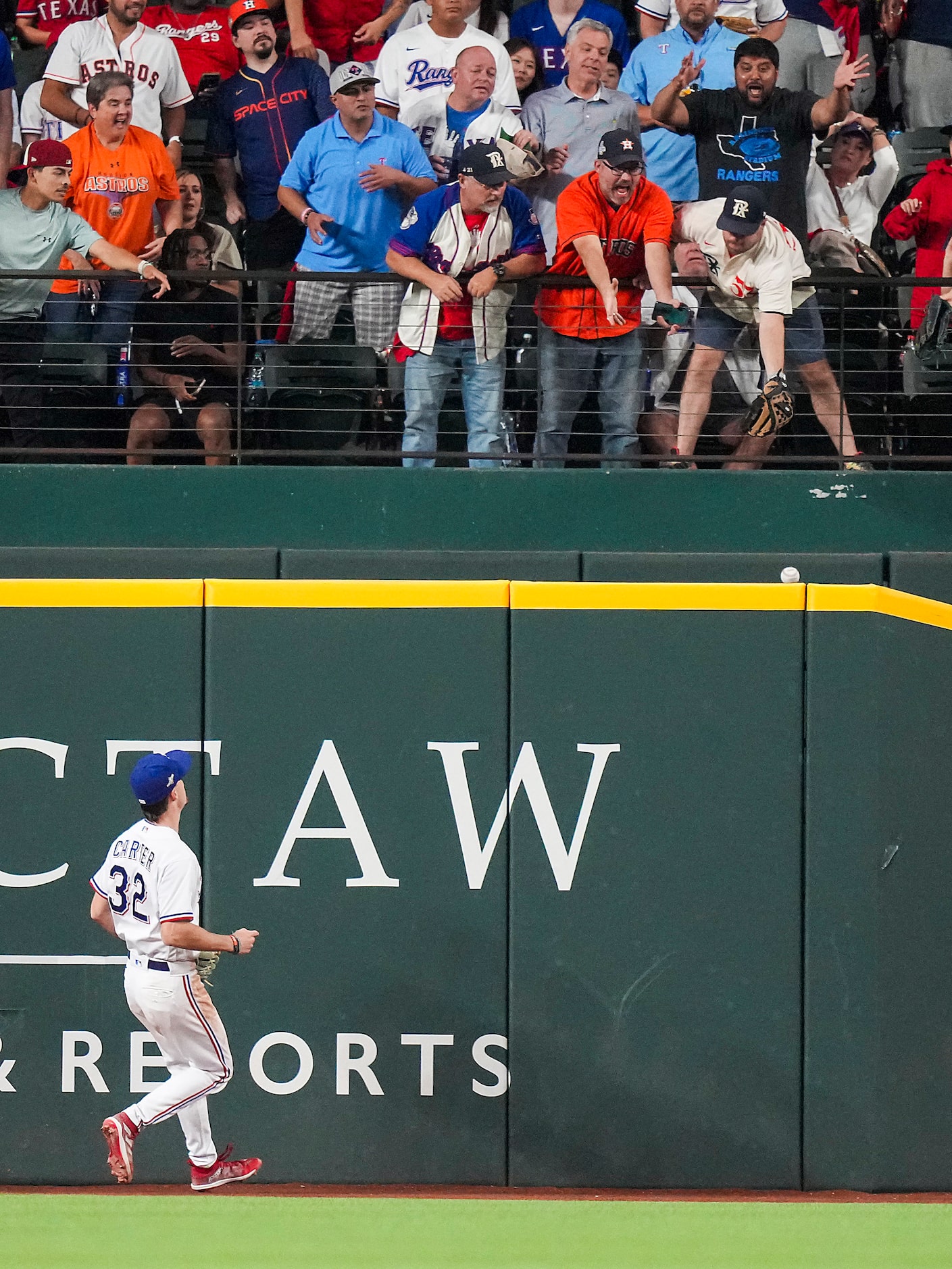 Texas Rangers left fielder Evan Carter  watches as a home run by Houston Astros left fielder...