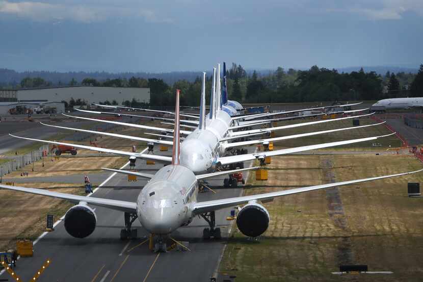 FILE - This June 18, 2013 file photo shows a line of Boeing 787 Dreamliners waiting to be...