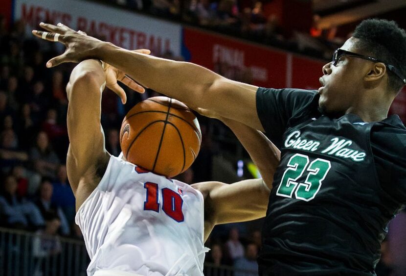 SMU guard Jarrey Foster (10) has the ball knocked away by Tulane forward Blake Paul (23)...