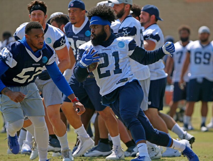 Dallas Cowboys running back Ezekiel Elliott (21) runs past linebacker Damien Wilson (57)...