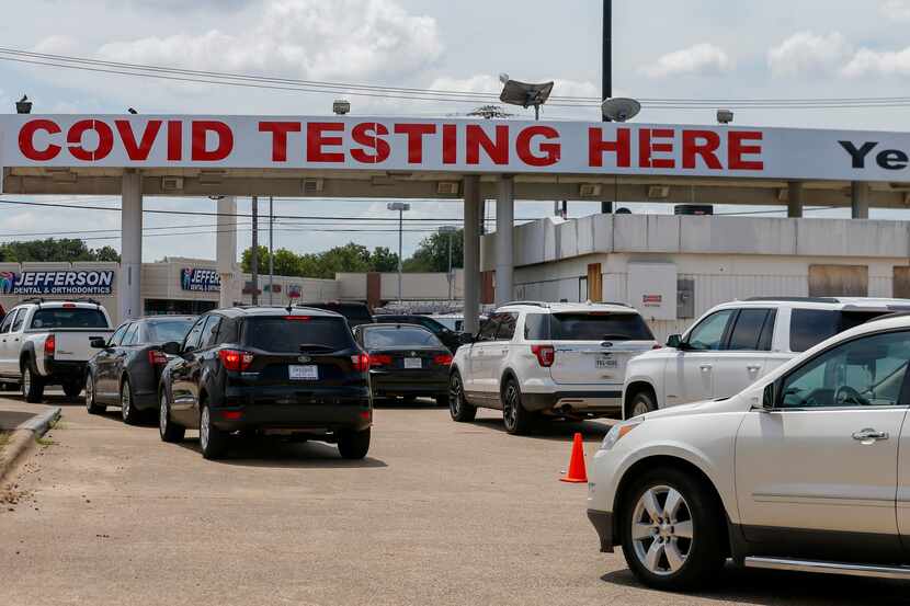 Dozens of people wait in cars for COVID-19 testing at YesNoCovid in Dallas on Aug. 13.
