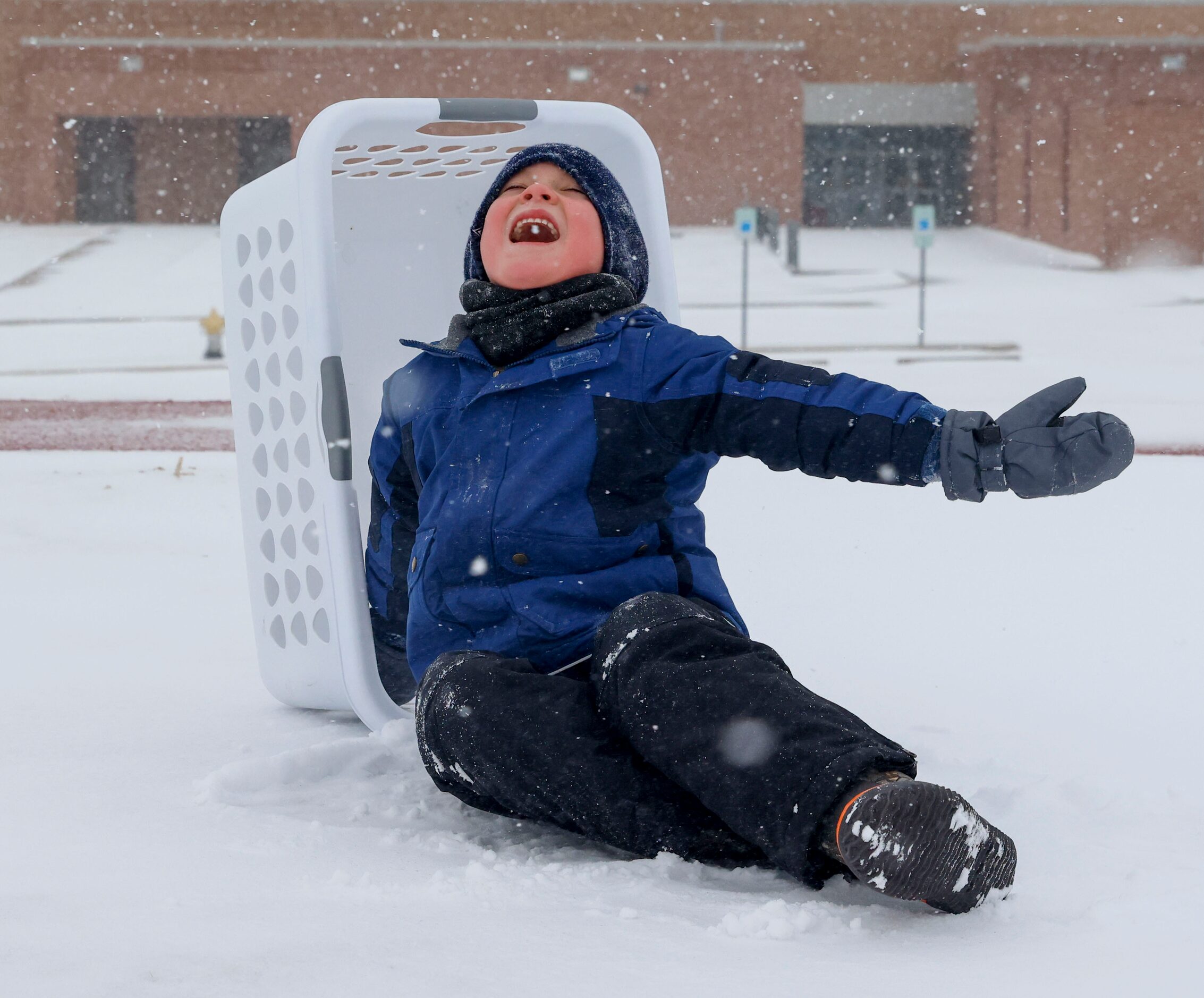 Preston Smith reacts as he attempts to taste the falling snow on Thursday, Feb. 3, 2022 at...