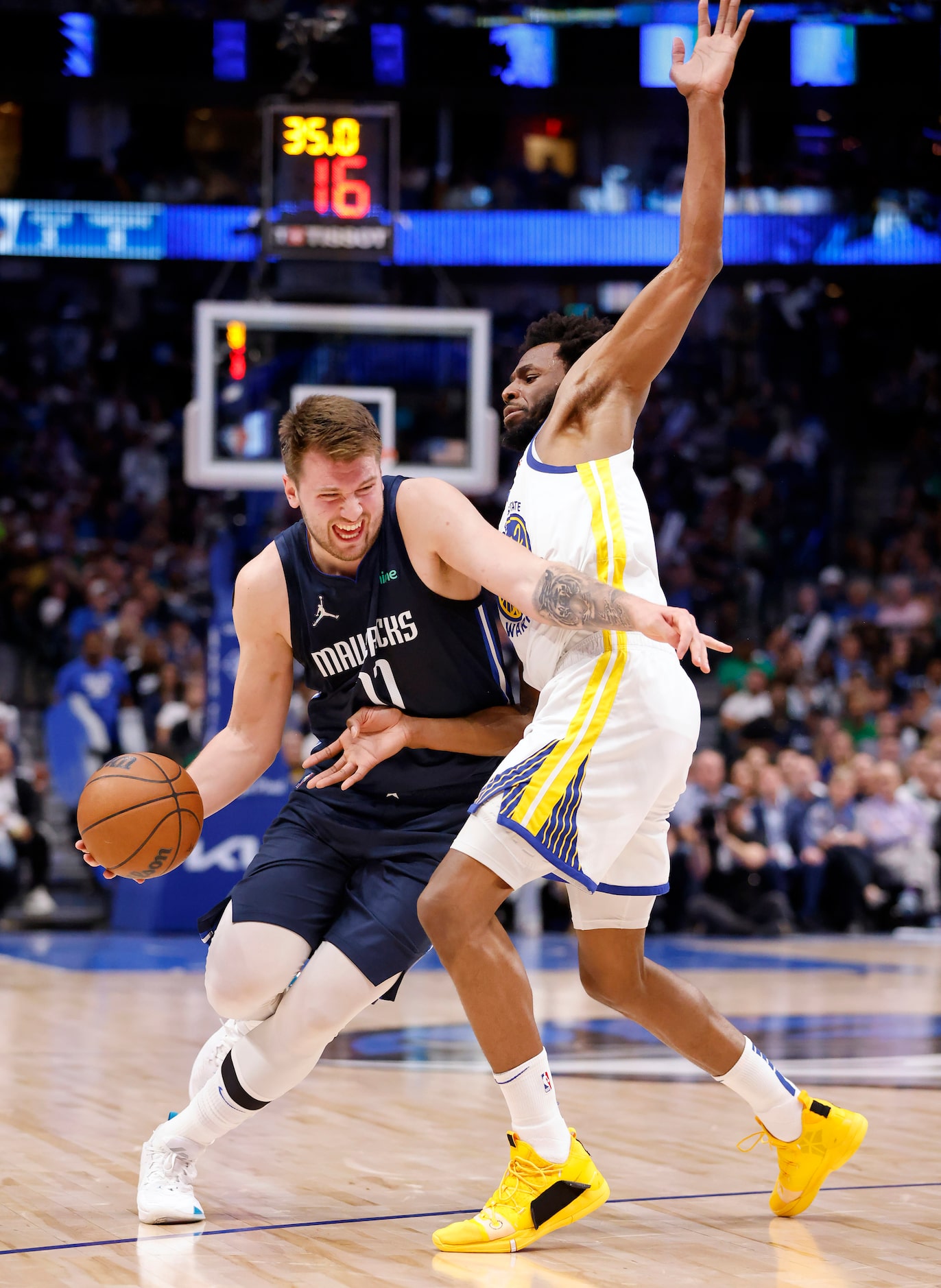 Dallas Mavericks guard Luka Doncic (77) tries to get around Golden State Warriors forward...