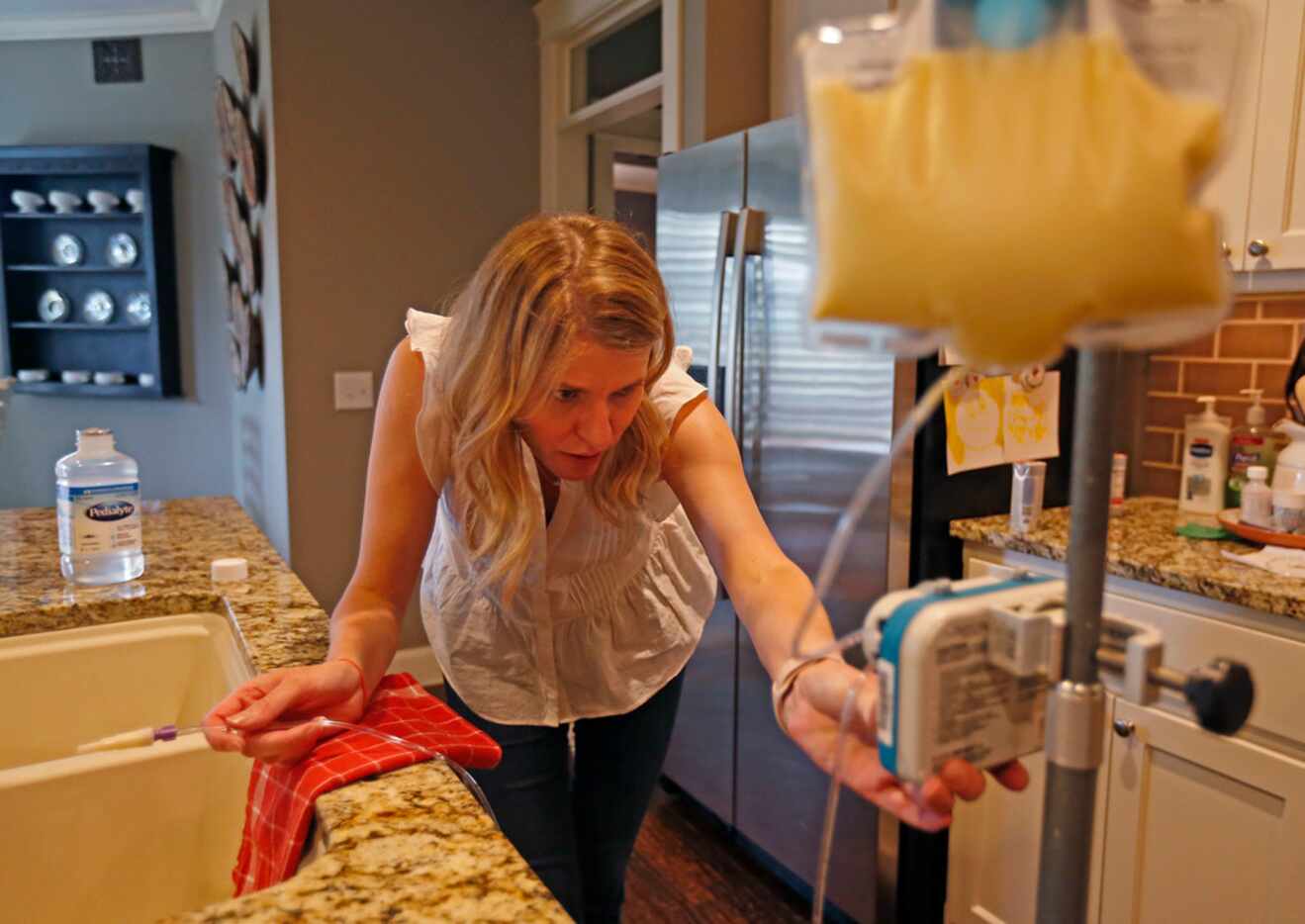 Kasey Woleben prepares food for son Will in the kitchen at her home in McKinney, Texas, on...