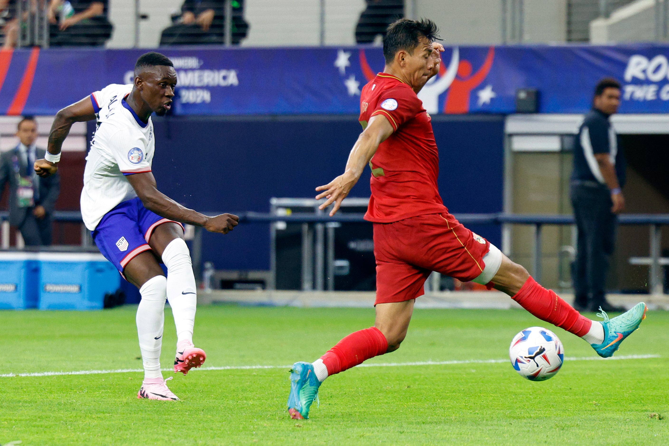 United States forward Folarin Balogun (20) scores a goal past Bolivia defender José Sagredo...