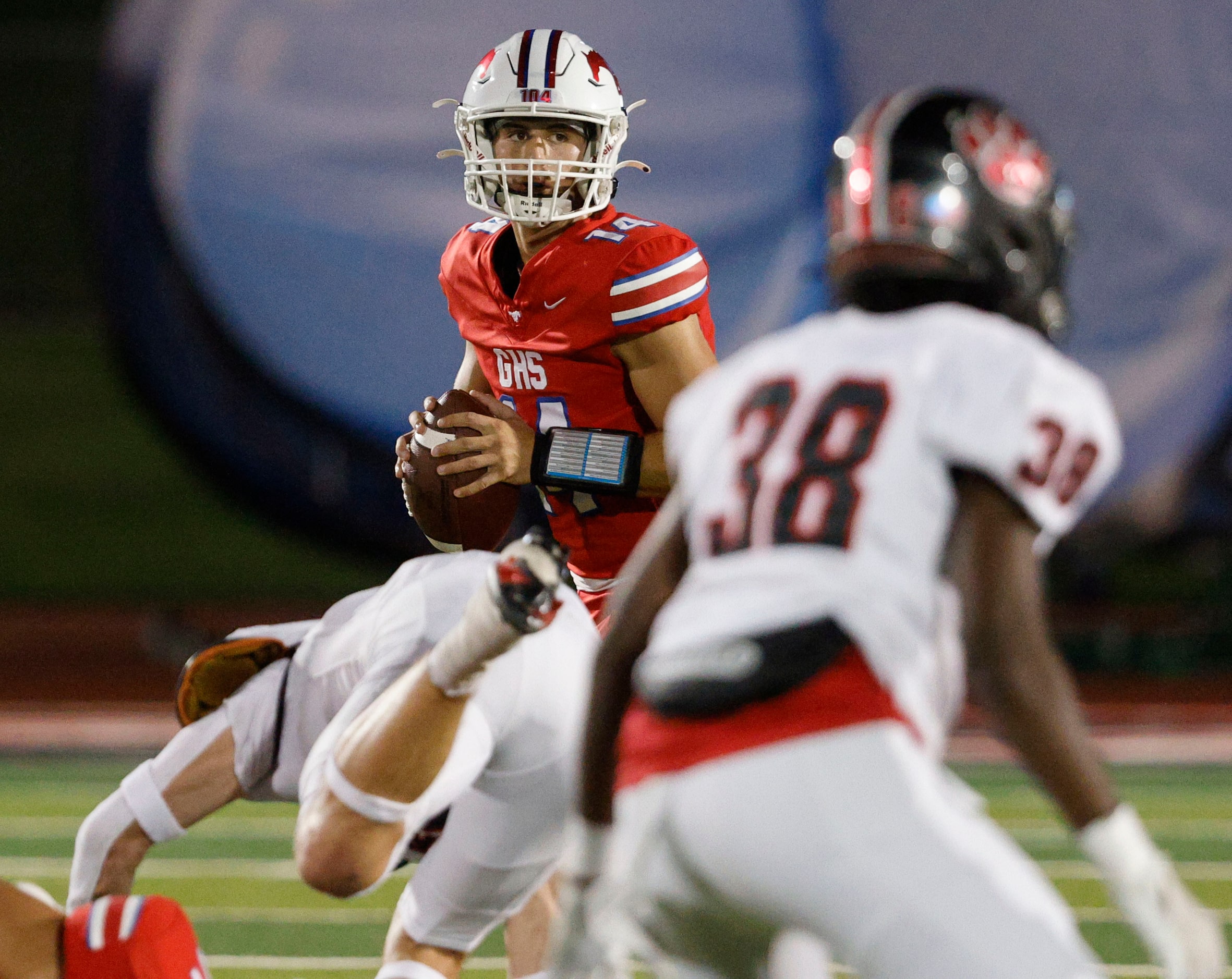 Grapevine's Harrison quarterback Hackbarth (14) looks to throw the ball against Grapevine...