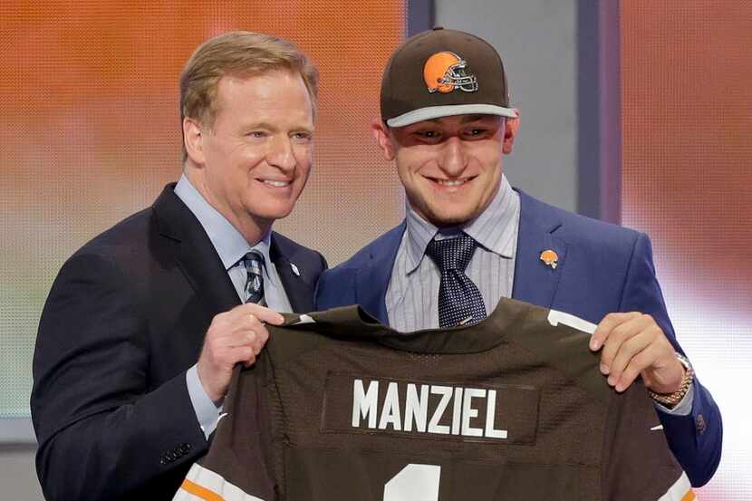 Texas A&M quarterback Johnny Manziel poses with NFL commissioner Roger Goodell after being...