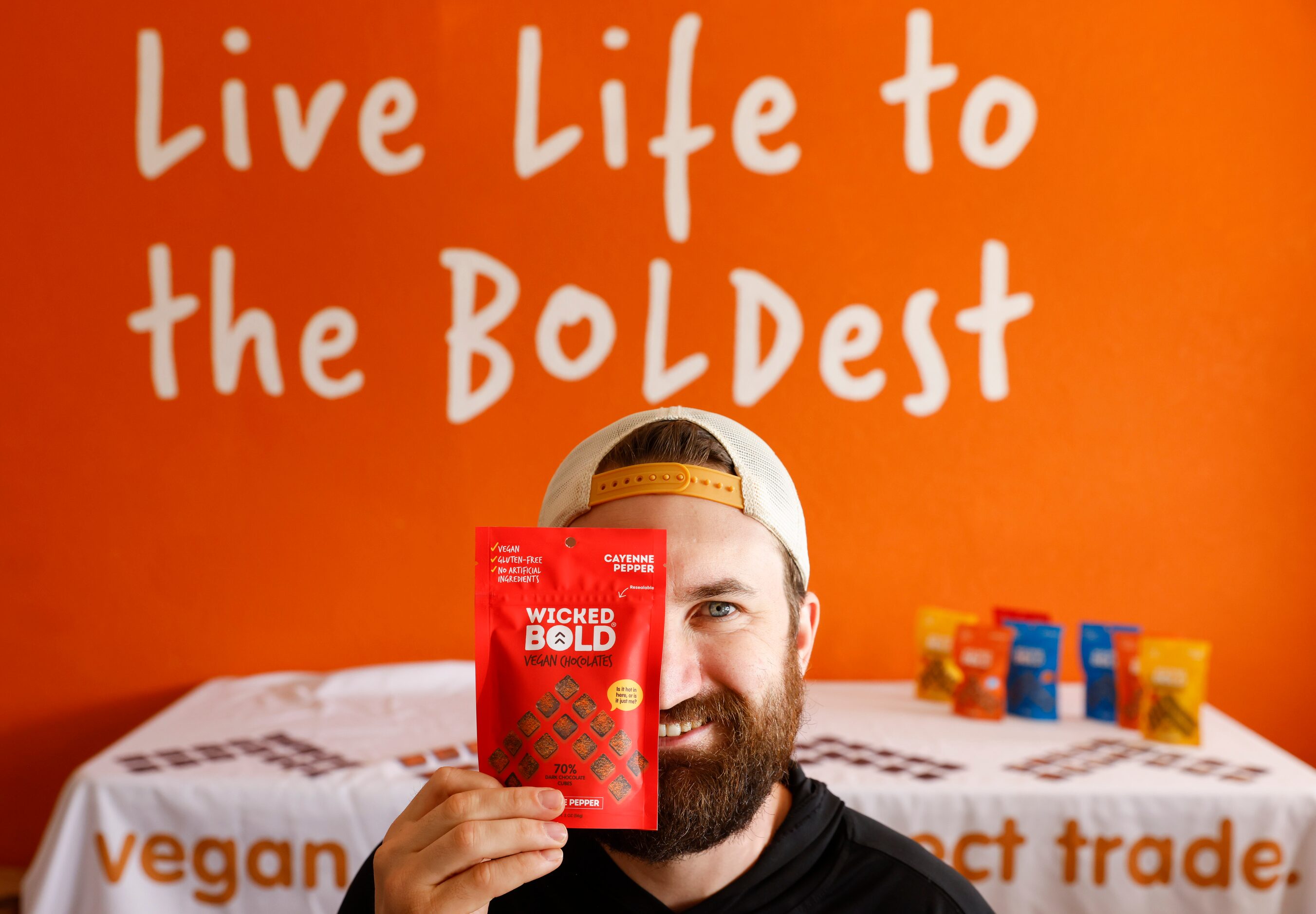 Deric Cahill poses with his Wicked Bold vegan chocolates at his chocolate factory in Flower...