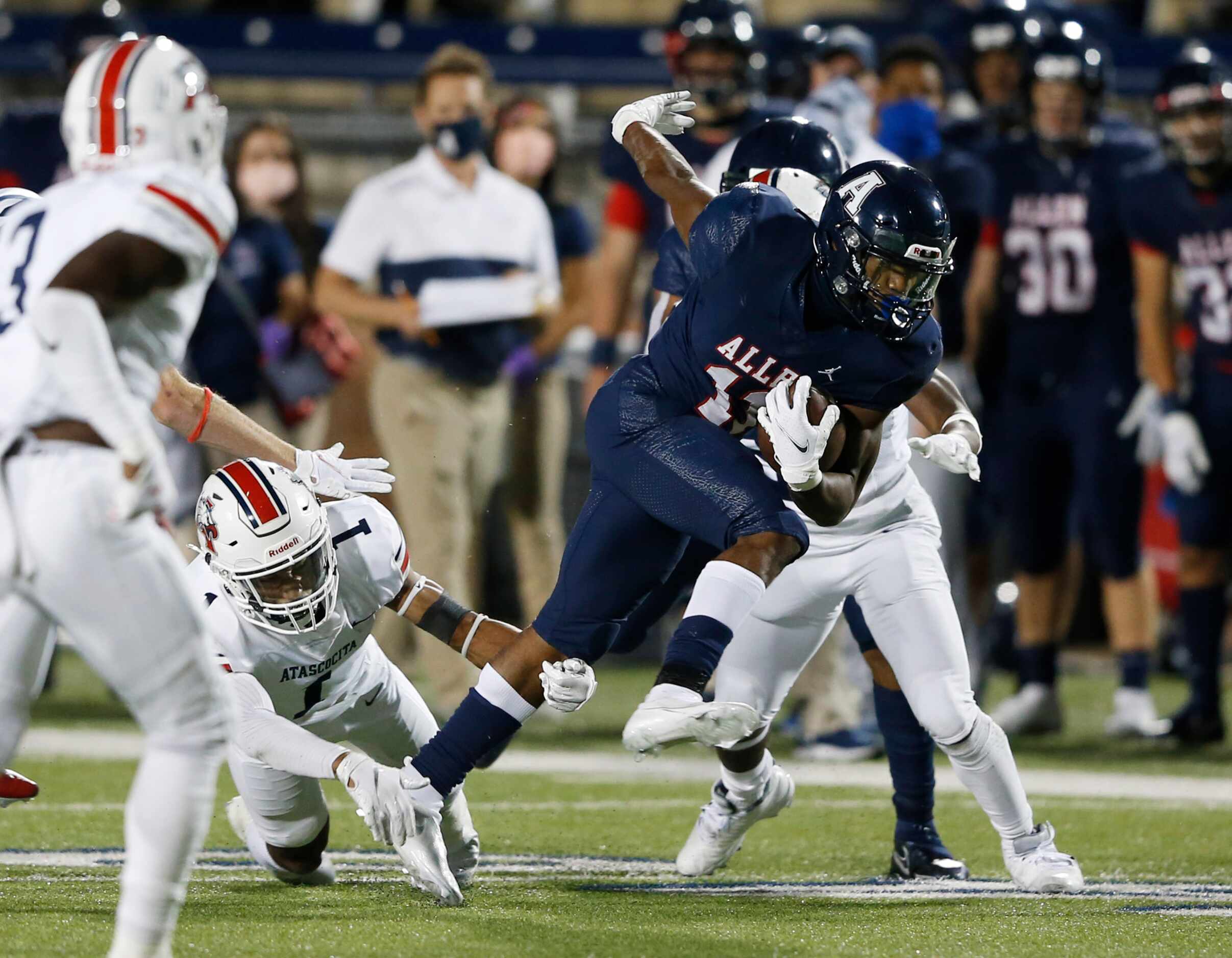 Allen's Jordan Johnson (11) is tripped up by Humble Atascocita's Jordan Augustine (1) on a...