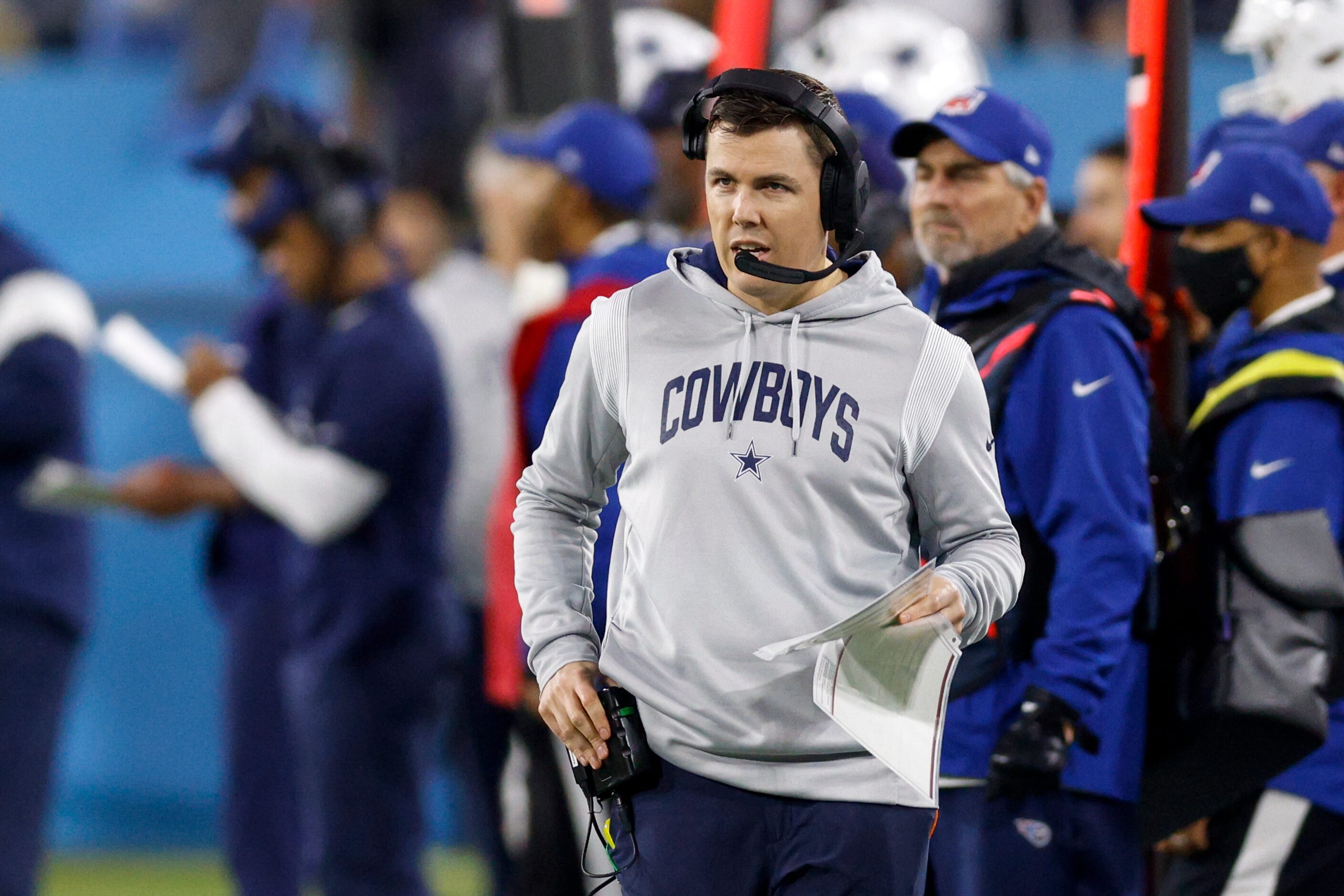 Dallas Cowboys offensive coordinator Kellen Moore walks the sideline during the first half...