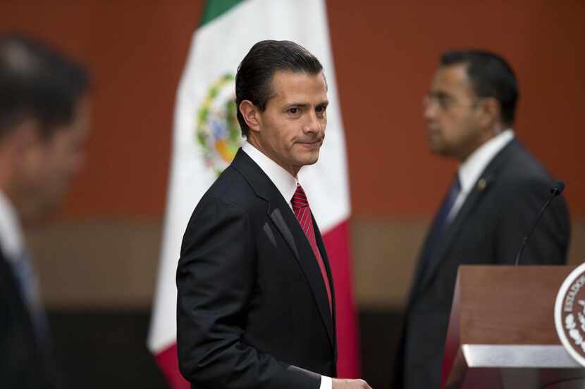 
Mexican President Enrique Pena Nieto arrives for a press conference following the capture...