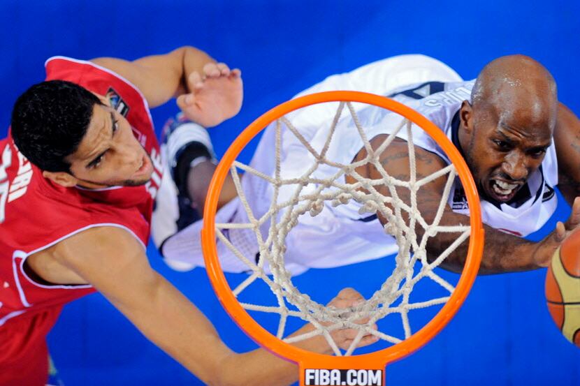 USA's Chauncey Billups, right, puts up a shot as Tunisia's Salah Mejri defends during the...