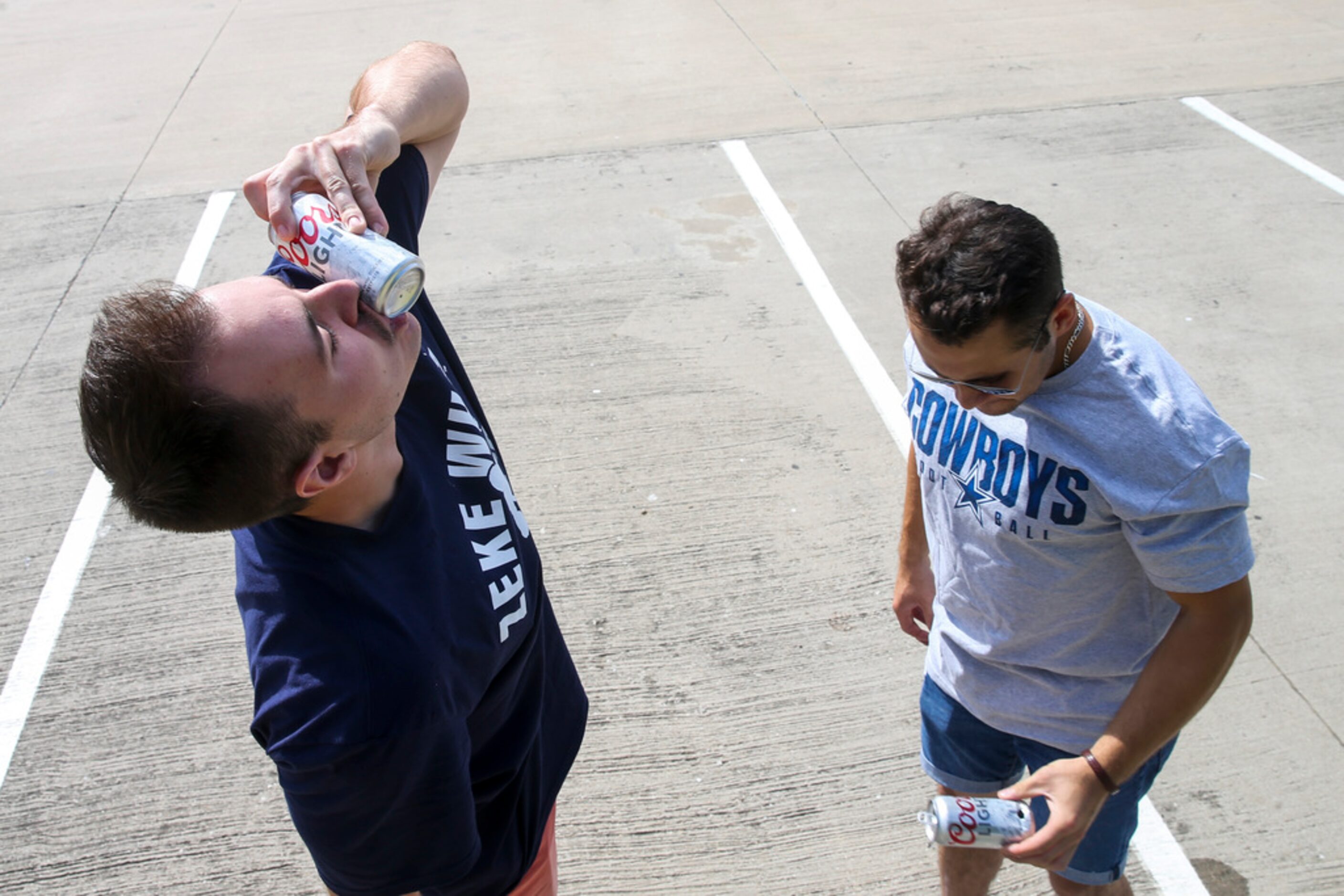 Aidan Brow, right, and Malcolm Glaholt, both of Vancouver, British Columbia, shotgun beers...