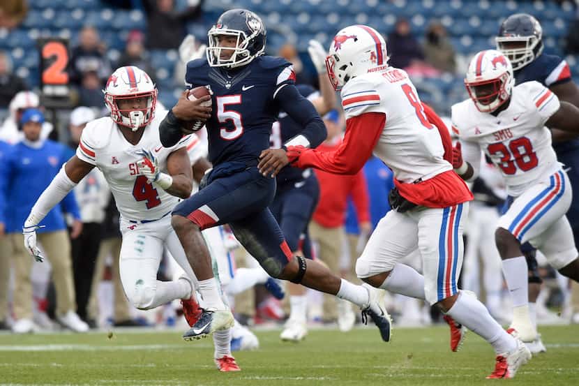 Connecticut quarterback David Pindell (5) finds an opening in the SMU defense as he sprints...