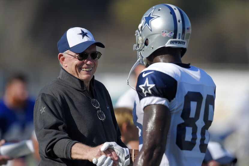 Dallas Cowboys owner Jerry Jones, left, talks with wide receiver Dez Bryant during a joint...