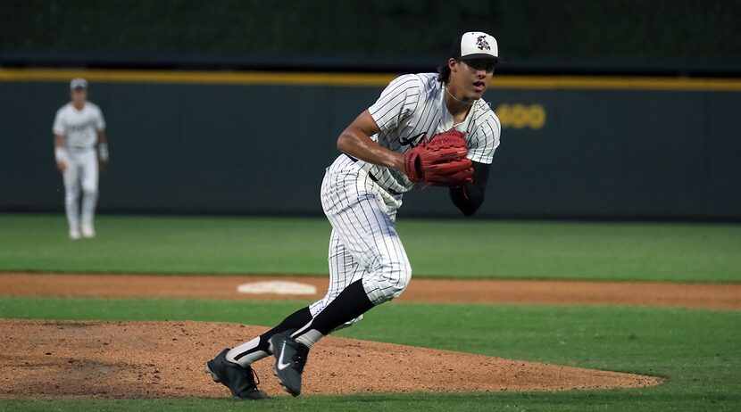 Argyle Park Prater, (7), picks up a short grounder hit Boerne Champion Sam Miller, (20), in...