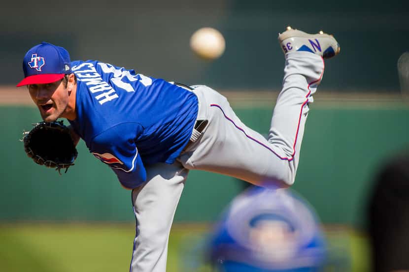 Texas Rangers pitcher Cole Hamels pitches during the second inning of a spring training...
