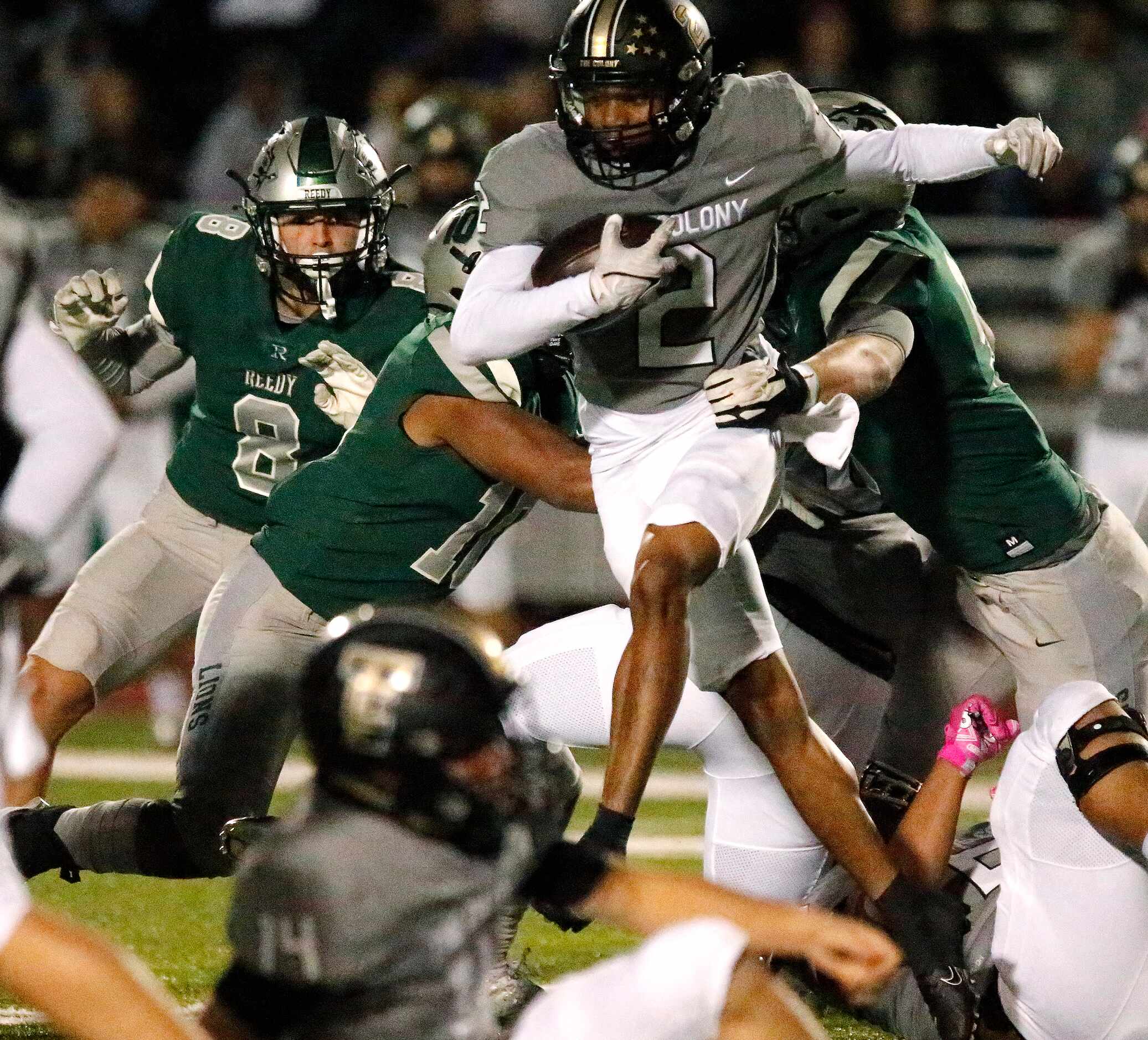 The Colony High School Shafiq Taylor (2) looks for room to run during the first half as...