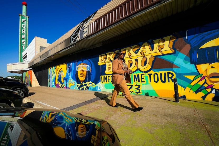 A guest walks in front of the theater on their way to a groundbreaking ceremony to launch...