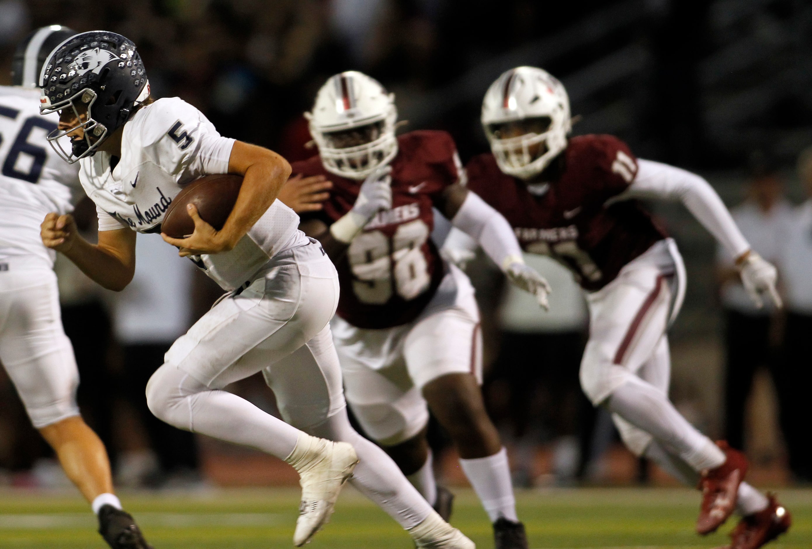 Flower Mound quarterback Jake Watson (5) takes off an a keeper as he is pursued by...