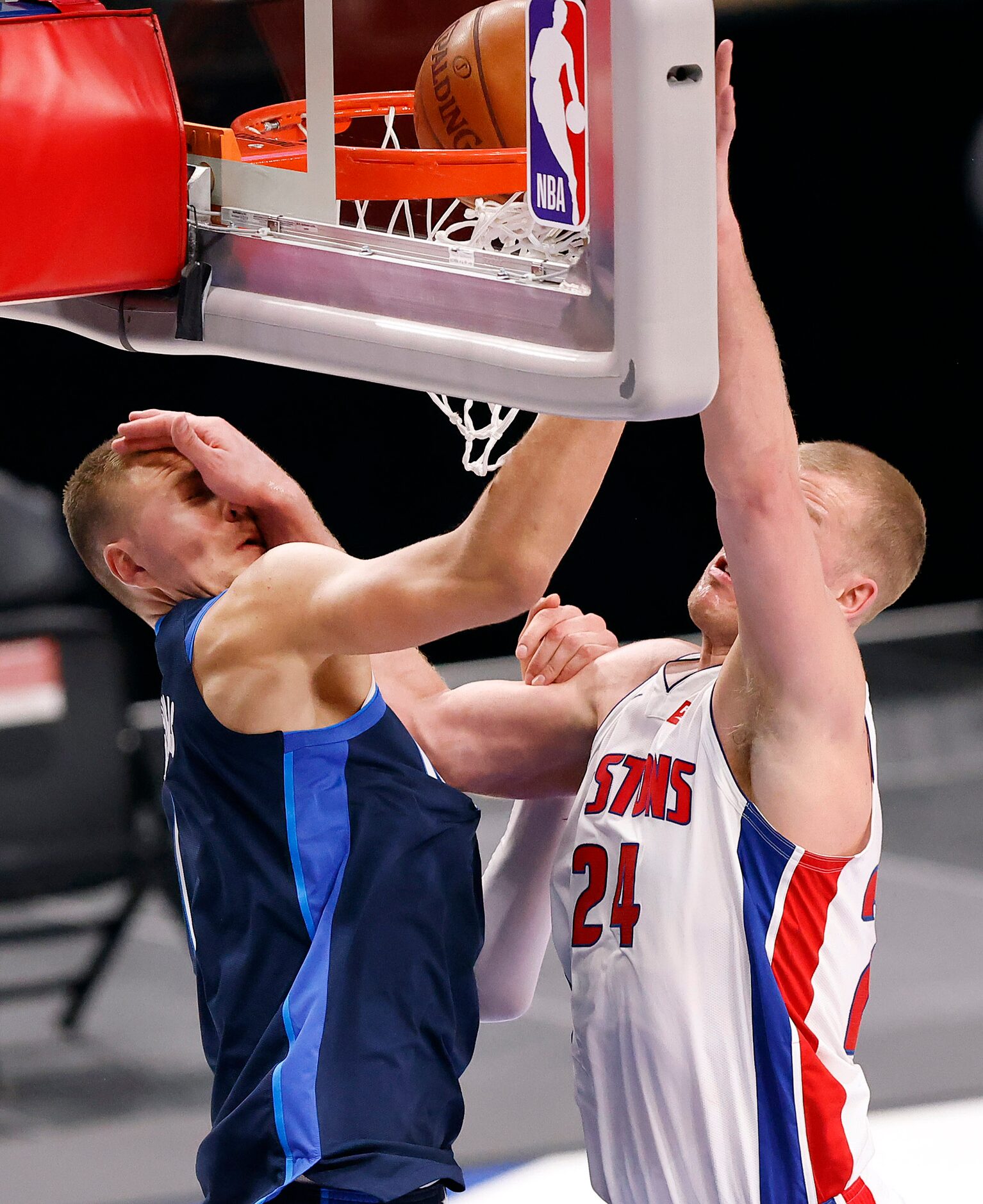 Dallas Mavericks center Kristaps Porzingis (6) receives a hand to the face as Detroit...