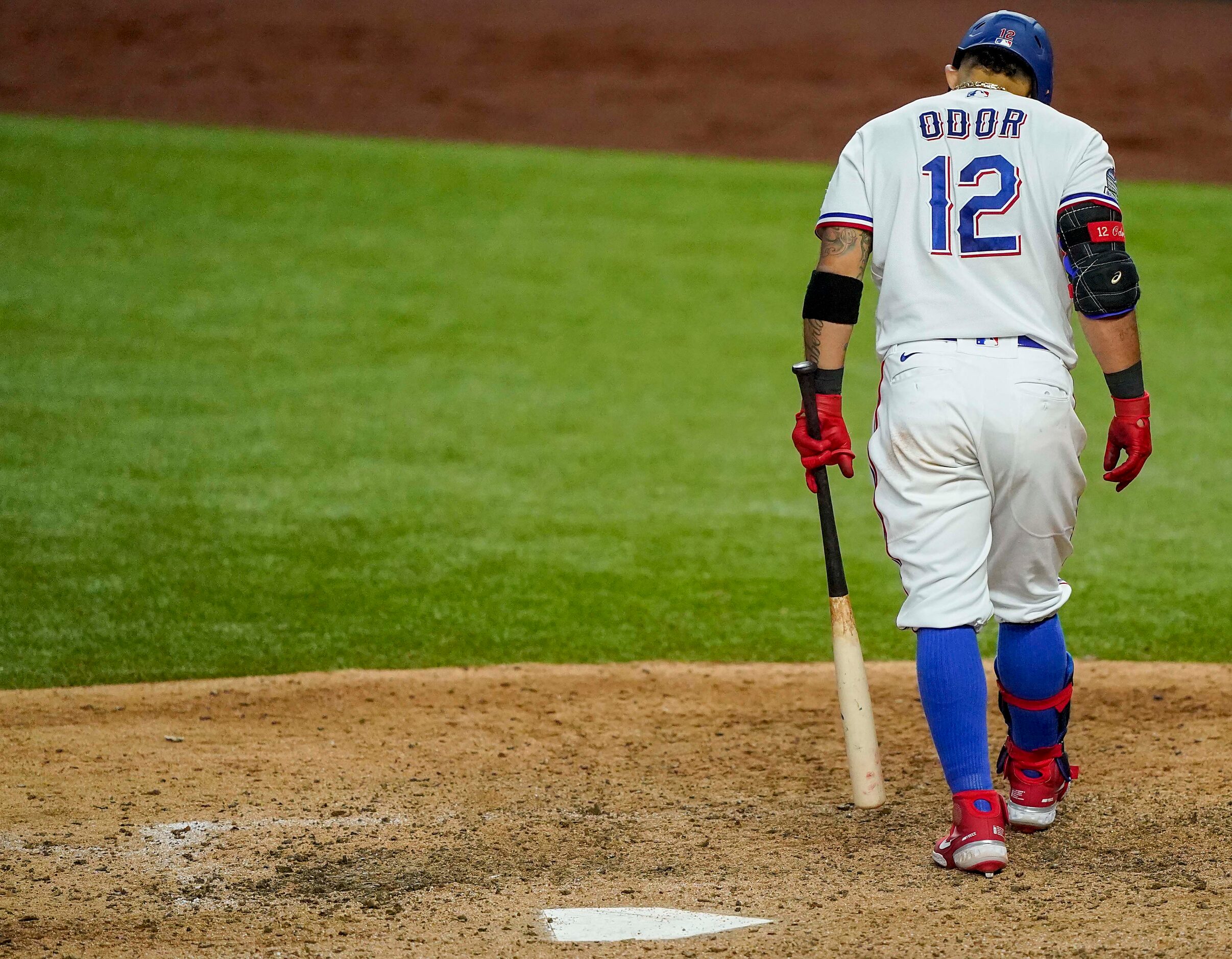 Texas Rangers second baseman Rougned Odor walks back to the dugout after taking a called...