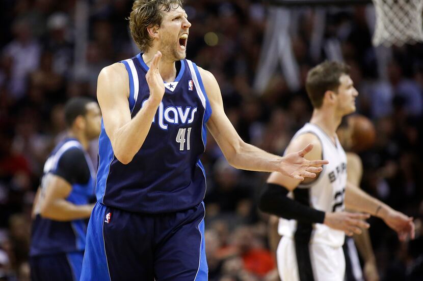 Dallas Mavericks forward Dirk Nowitzki (41) gets his teammates fired up as he took over in...