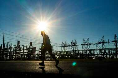 A runner passes the Oncor Cedar Hill Switchyard in Dallas.