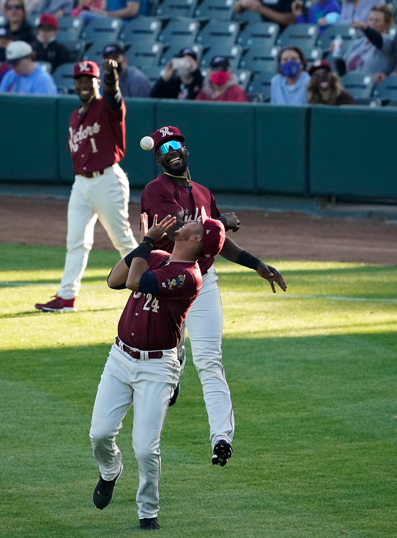 Frisco RoughRiders players Dio Arias (24), Sherten Apostel (12) and J.P. Martinez (1) toss a...