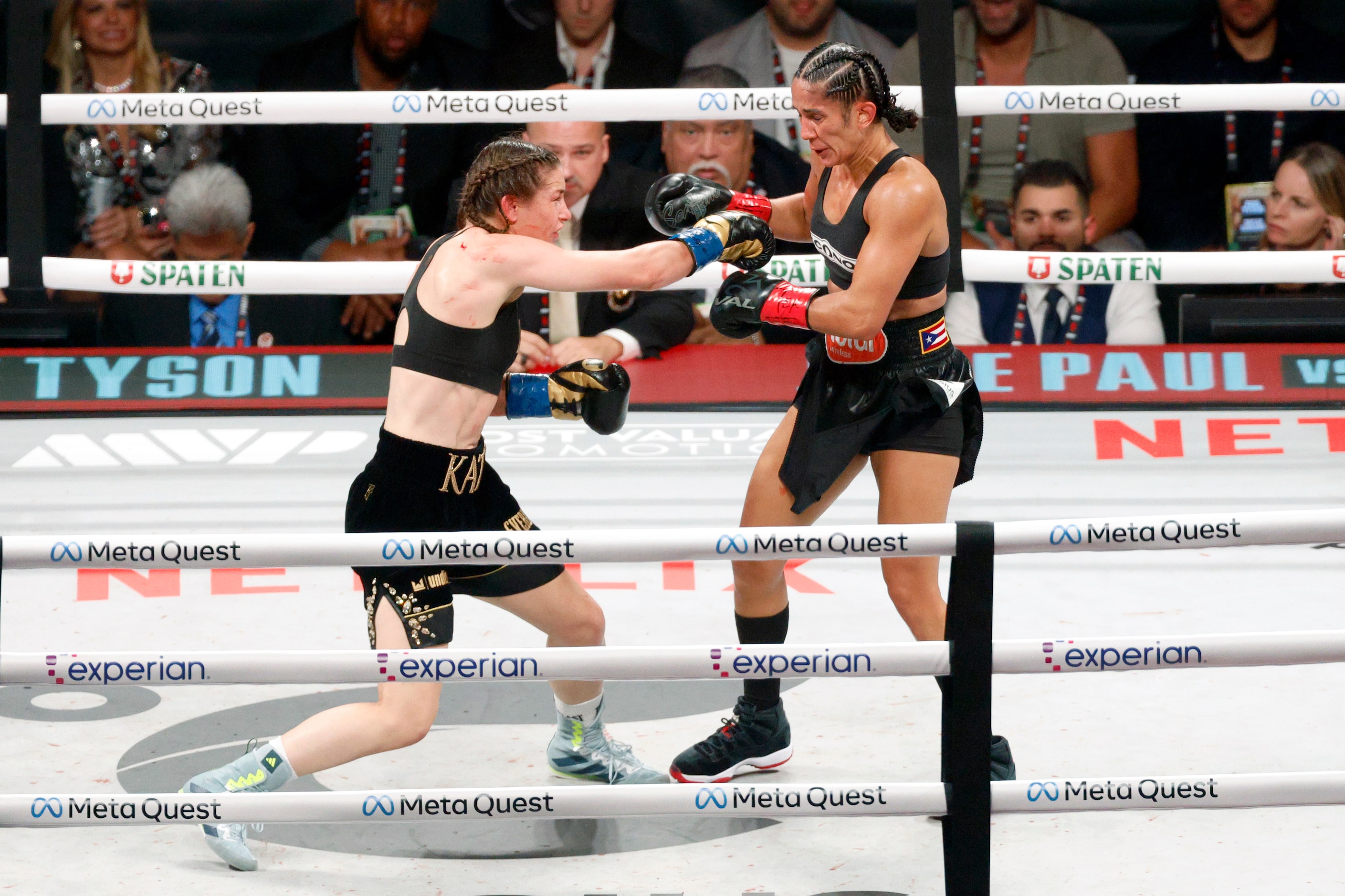 Katie Taylor (left) and Amanda Serrano exchange blows during round five of the undisputed...