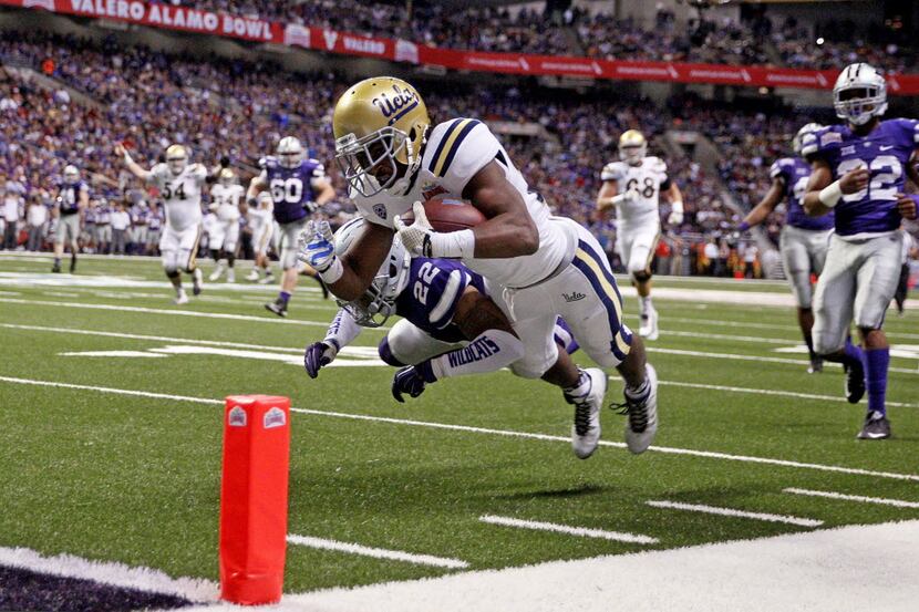 UCLA Bruins running back Paul Perkins (24) dives in for the touchdown against Kansas State...