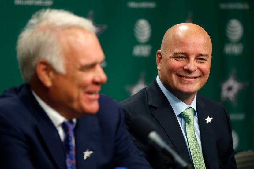 New Dallas Stars head coach Jim Montgomery, right, smiles as Chief Executive Officer Jim...