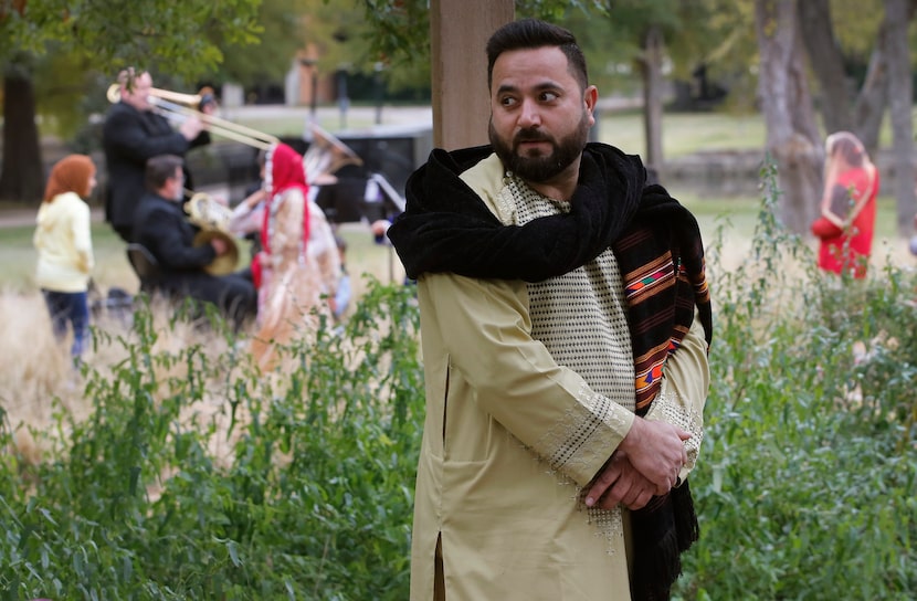 Ahmad Shah, 37, listens as members of the Dallas Symphony Orchestra performed at a barbecue...