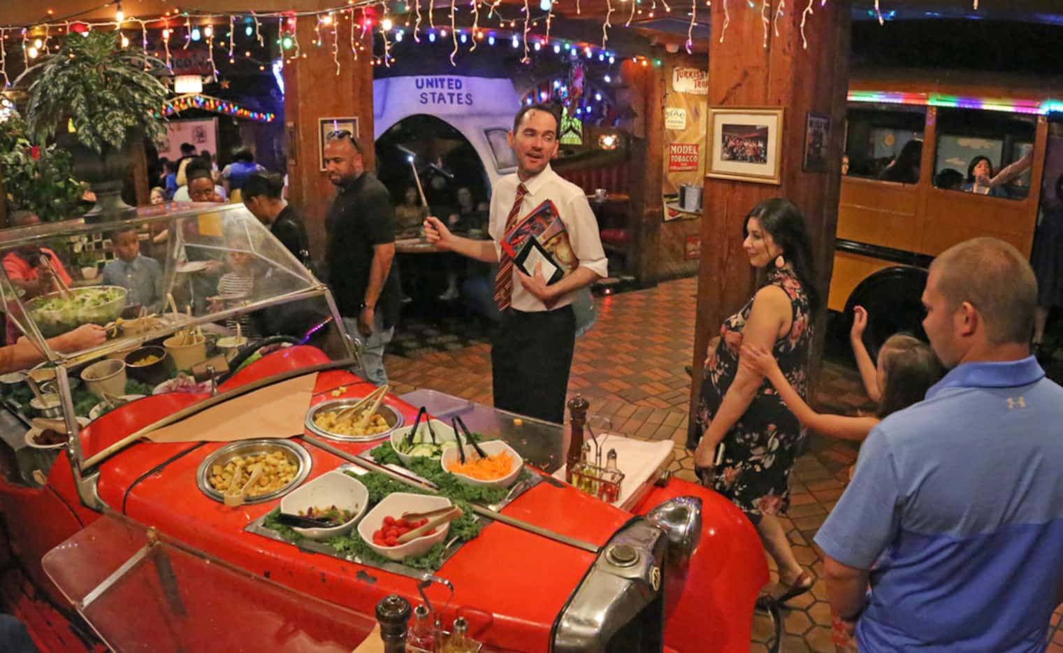 An antique car serves as a unique salad bar at the Magic Time Machine on Beltline Road in...