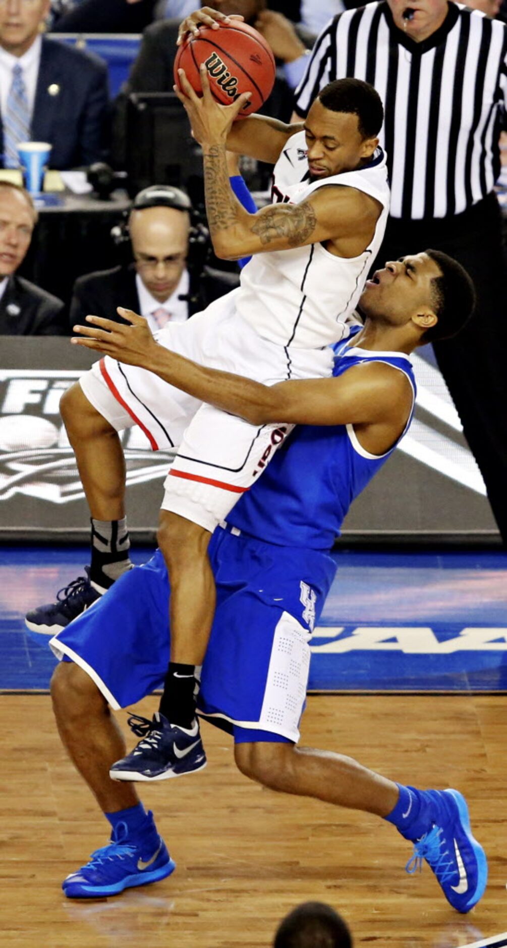 Connecticut Huskies guard Ryan Boatright (top) lands on top of Kentucky Wildcats guard...