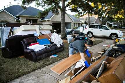 Chumming Xu looks through his flood damaged belongings in the aftermath of Hurricane Harvey...