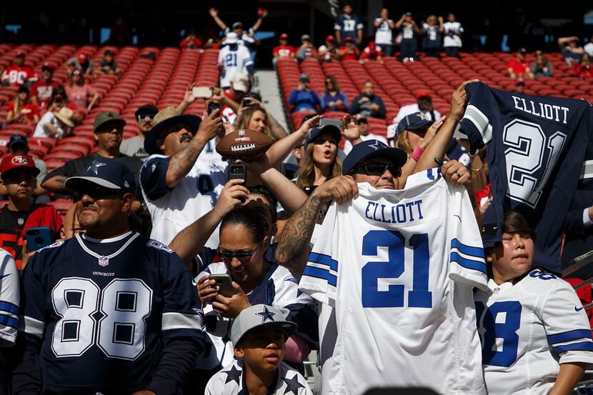 Dallas Cowboys fans cheer running back Ezekiel Elliott (21) as the teams warm up before an...