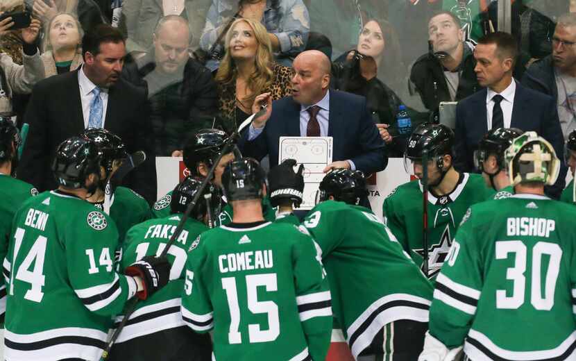 Dallas Stars head coach Jim Montgomery talks to the team during a timeout in the third...